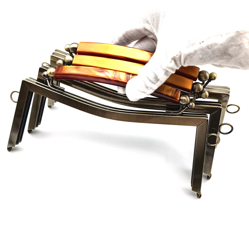 Exquisted customized hanging brush anti brass round ball kiss lock resin handle purse bag metal frame 21CM